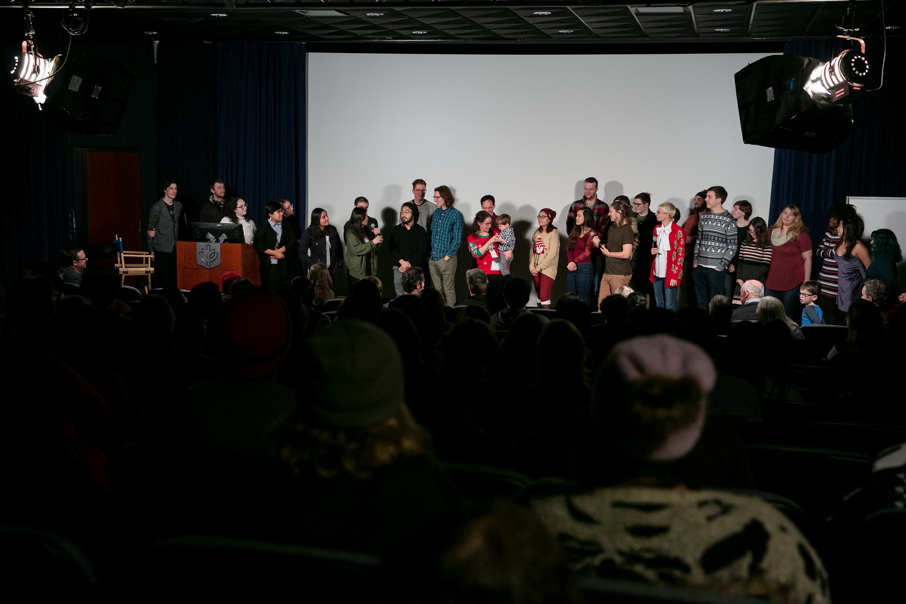 Student filmmakers take questions from the audience during the premiere of their stop-motion film “Merry Christmas from DePaul,” which is part of a holiday window display on the State Street side of DePaul’s Loop Campus. (DePaul University/Randall Spriggs)